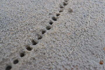 water droplets form a hole in the fine sand. natural background
