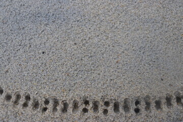 water droplets form a hole in the fine sand. natural background