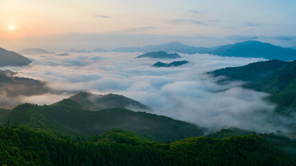 Sunrise over flowing fog between mountain peaks 