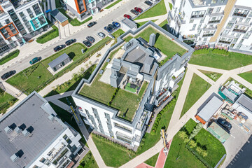 neighborhood family house with green lawn on flat rooftop. aerial overhead view.