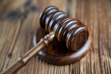 Lawyer office. Gavel and legal books on the judge rustic wooden desk.