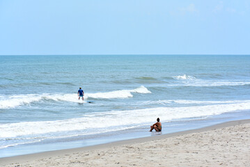 Surfer with spectator in Cocoa Beach, Florida