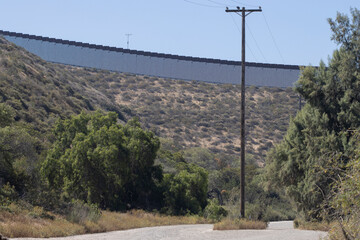 A vertical border wall between the United States and Mexico, separating San Diego from Tijuana,...