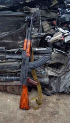 AKM(Avtomat Kalashnikova) version of Kalashnikov assault rifle and car wreck. Ukraine