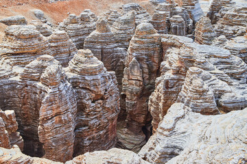 Network of exposed rock formations and paths in sandy landscape