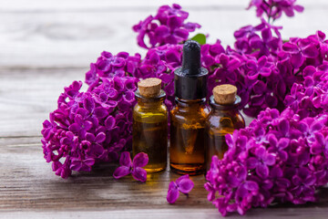Fototapeta na wymiar Lilac essential oil in a small bottle.