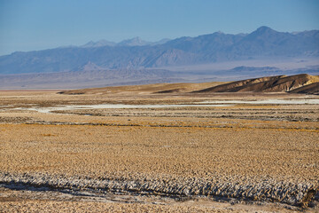 Open desert plains with mountains in distance