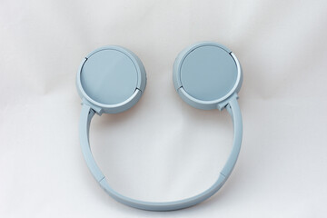 Close-up gray wireless headphones on white background.