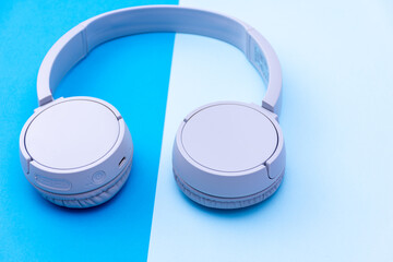 Close-up wireless headset isolated on a blue background.