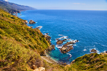 Spring on the west coast with cliffs and large rocks being hit by ocean waves