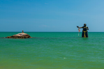 Giant statue characters in Phra Aphai Mani on green turquoise sea