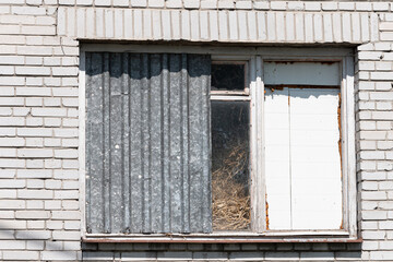 Fototapeta na wymiar Window in an old neglected building