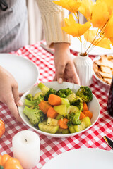 woman preparing vegetables for thanksgiving dinner at home kitchen
