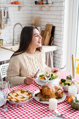 Obraz na płótnie Canvas woman having thanksgiving dinner at home kitchen celebrating holiday