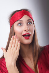 Shocked young lady, covers mouth with hand