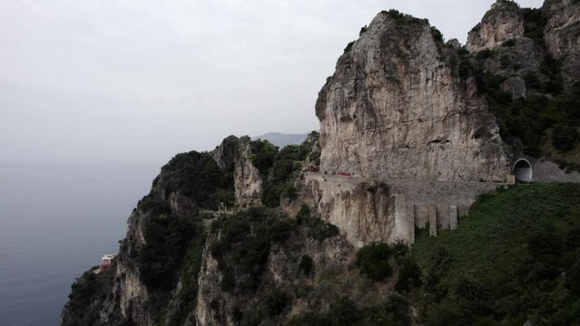 Drone video of plane discovery over the Cetara Viewpoint on the Amalfi Coast, Italy. video begins with a low flight over the road and rises discovering the Amalfi coast.
