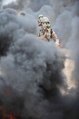 Almaty, Kazakhstan - 08.22.2012 : Soldiers pass a burning obstacle course in gas masks.