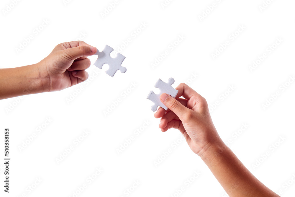 Wall mural close up hand two people holding jigsaws connecting puzzle elements on white isolated background