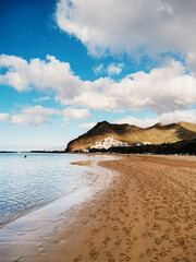 AMazing view of sand beach tropical with blue water and sky in background. People footprints on the ground. Concept of tourism and scenic place destination. Summer holiday vacation leisure lifestyle