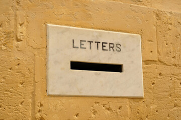 Mailbox slot in the door with vintage lettering