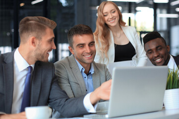 startup business team on meeting in modern bright office interior brainstorming, working on laptop and tablet computer