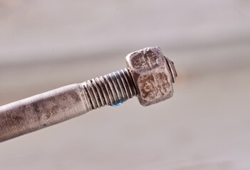 Blue thread lock on a bolt with a nut