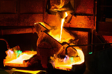 Pouring liquid copper metal for anodes into form in workshop