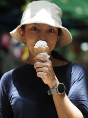 Young asian beautiful woman with her coconut ice-cream waffle cone 
