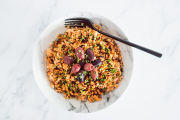 healthy plant-based food, vegan wheat noodles with shredded teriyaki tofu and olives topped with chives