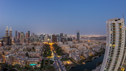 Panorama with skyscrapers in Barsha Heights district and low rise buildings in Greens district aerial day to night timelapse.