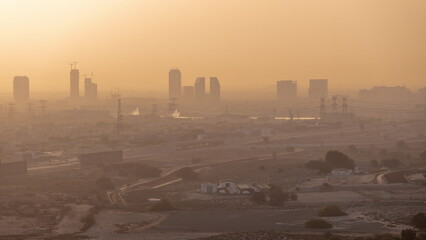 Dubai skyline with villa houses and construction site of new towers on a background aerial timelapse.