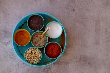 Indian spice box on wooden background with copy space,Cardamom, turmeric, chilli powder, salt,mustard seeds,cumin, selective focus,cardamom, turmeric, chilli powder, salt,mustard seeds,cumin,
