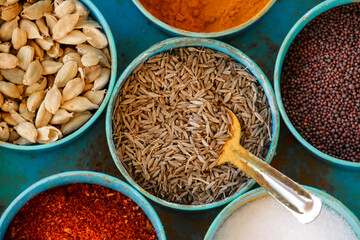 Spice box Indian masala dabba,indian spice box on wooden,Cardamom, turmeric, chilli powder, salt,mustard seeds,cumin,blur background