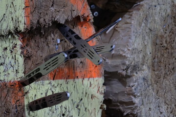 Almaty, Kazakhstan - 02.12.2019 : Throwing knives at a wooden target in a training club.