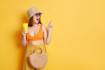 Indoor shot of astonished amazed woman in sunglasses wearing summer clothing posing isolated over...