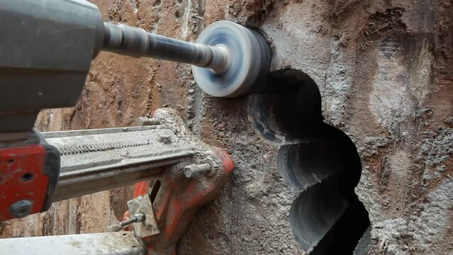 drilling a hole in a concrete pipe with a diamond tool