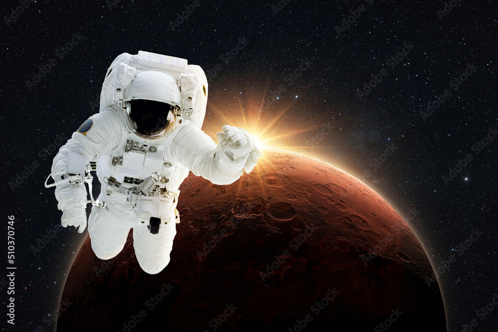 Poster New spaceman flies in gravity in outer space on a backgrounds of the amazing red planet Mars with orange dawn rays in space. Astronaut Journey to the Planet Mars Concept