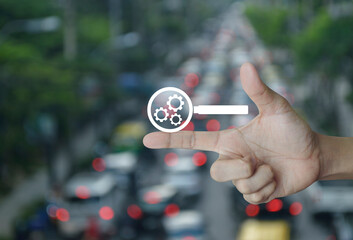 seo flat icon on finger over blur of rush hour with cars and road in city, Technology search engine optimization concept