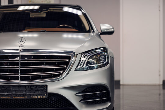 Samara, Russia - 02.05.2022: Close-up logo Mercedes-Benz S class in silver color. A car on the background of a showroom. The front of the car and the radiator grille and headlights. Premium and luxury