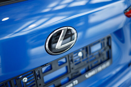 Samara, Russia - 02.05.2022: Close-up logo new LEXUS NX 300 in blue color. A car on the background of a showroom. The back of the car. Taillights and brake lights. LED