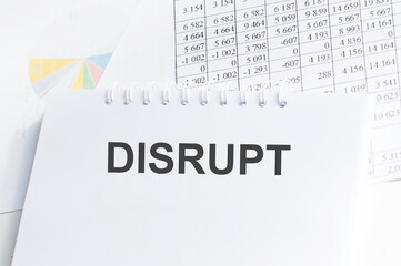 DISRUPT text text on notepad on background reports, business concept