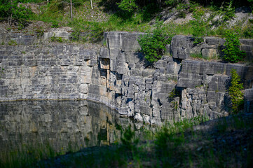 open quarry filled with water with high wall