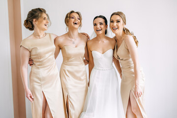 cheerful girls on the wedding day. Beautiful bride and bridesmaids before the ceremony