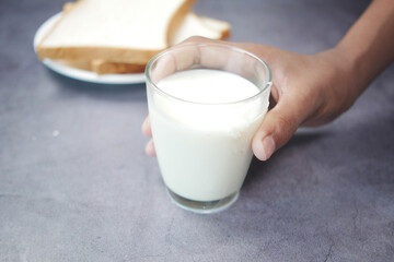 hand pick a glass of milk on black 