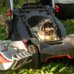 repair of a lawn mower by a gardener in a country house