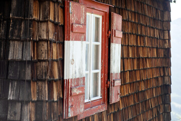 Traditional window shutters in red and white. Austria. Europe