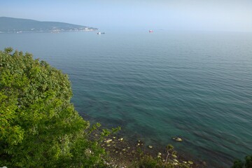 Travel along the Black Sea coast. Beautiful view from above to the endless sea, high mountains, blue sky. A summer day.