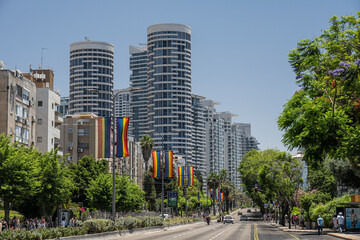 Fototapeta na wymiar LGBT flags against a background of buildings in Namir Avenue in the city of Tel Aviv, during LGBT week in June 2022.