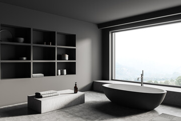 Obraz na płótnie Canvas Grey bathroom interior with bathtub, shelf with decoration, window