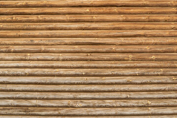 Wooden wall from logs of pine as a background texture.